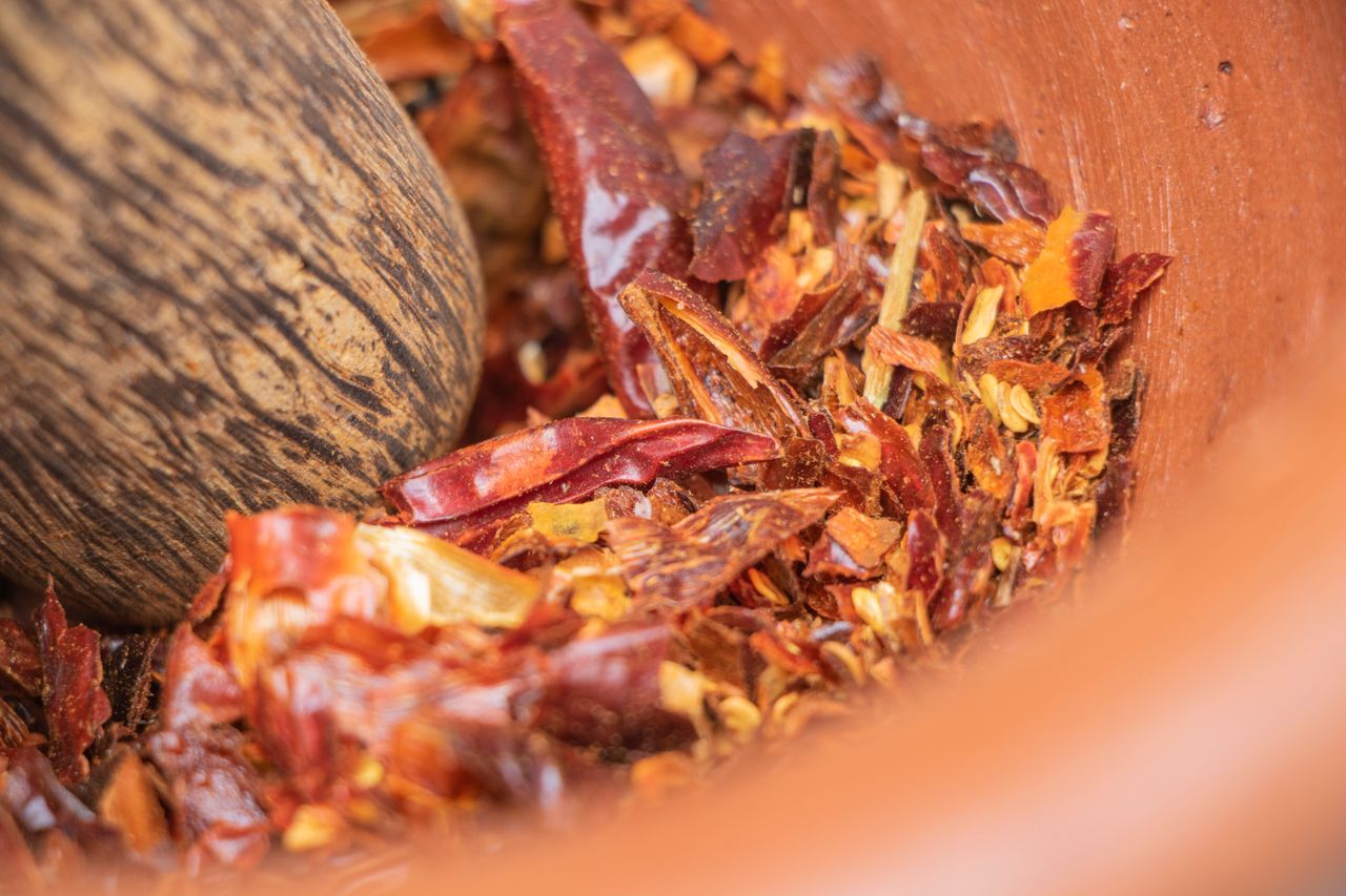 Crafting Captivating Headlines: Your awesome post title goes here Close-up of crushed red chili peppers in a mortar, showcasing spicy ingredients.