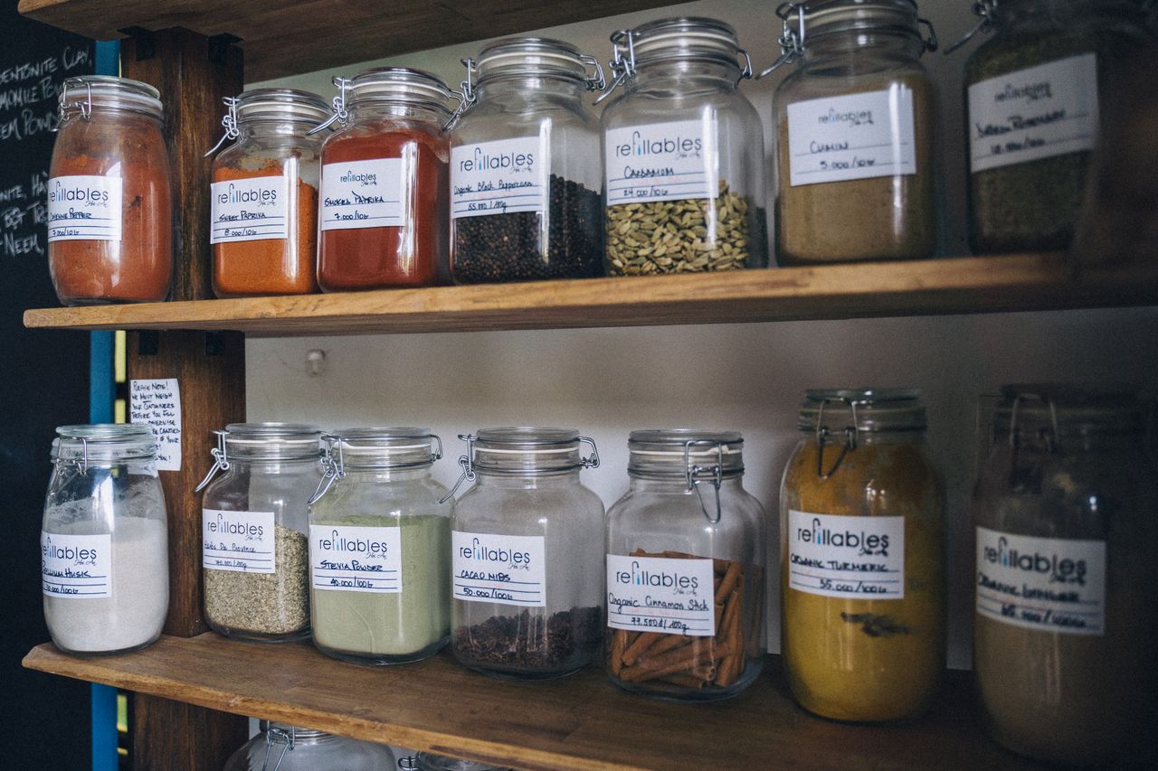 Mastering the First Impression: Your intriguing post title goes here Glass jars filled with spices and labels on a wooden shelf for eco-friendly storage.